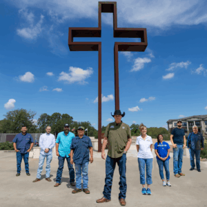 JK Welding's team in front of a patina cross done and installed by the JK Welding team