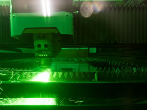 Laser cutting aluminum at JK Welding in Houston, TX. CNC laser cutter produces precise aluminum parts with clean edges for fabrication and production work.